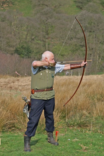[long bow archer taking aim]