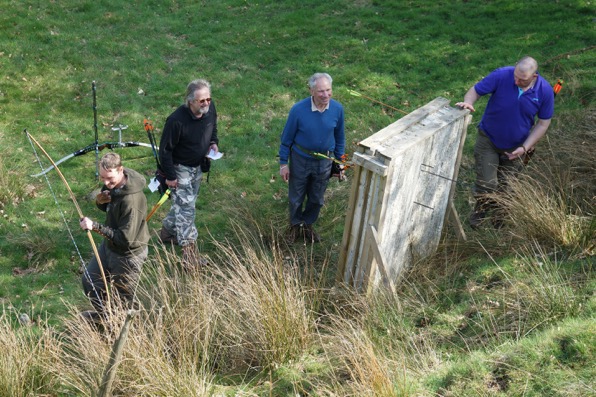 [scoring target and looking for arrows]