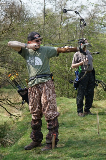 [compound archer taking aim]